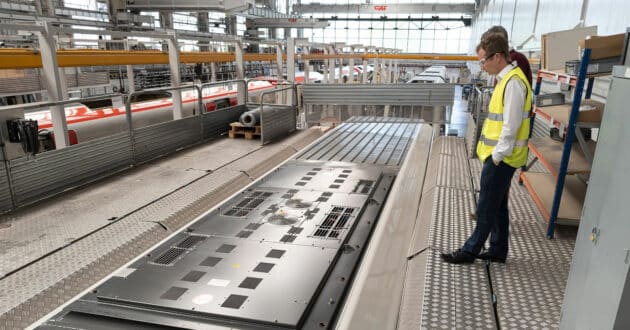 Workers inspecting the roof of a train at the CAF factory in Beasain (CC BY-SA) TOMPAGENET-Wikimedia Commons.