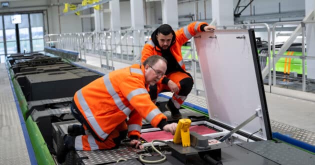 Maintenance workers working on the roof of a train. © CAF.
